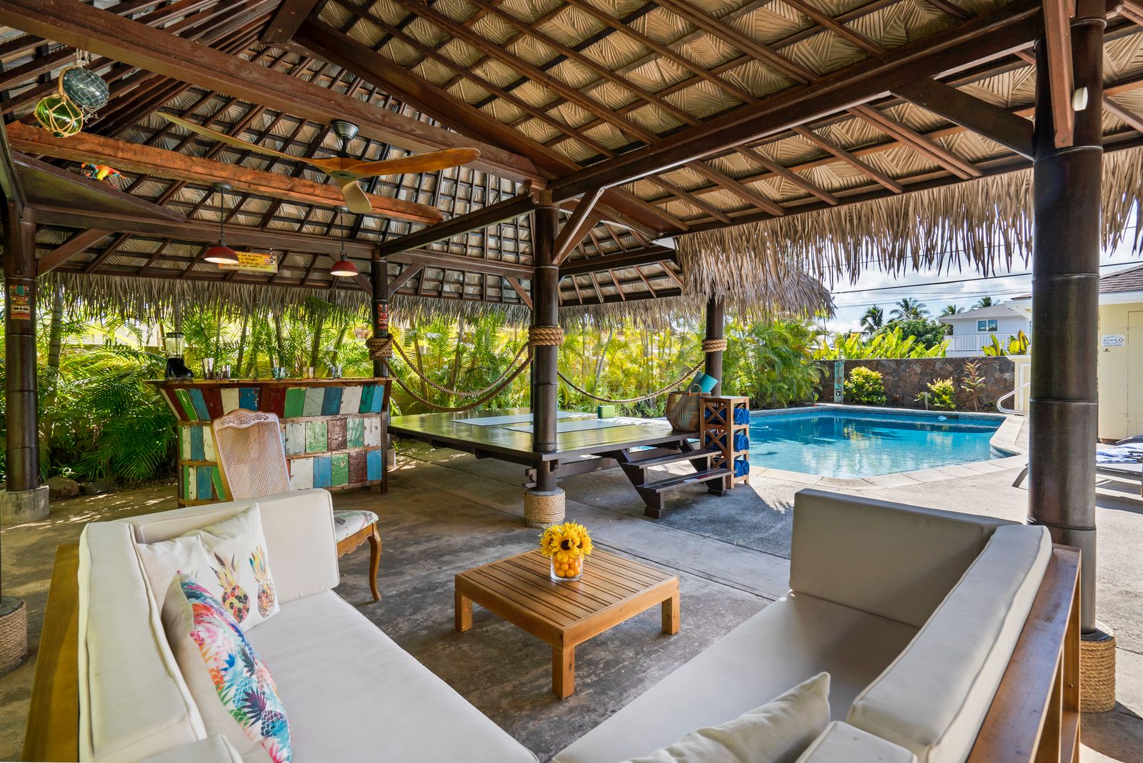 Outdoor living space with pool by Enoch Pool Builders